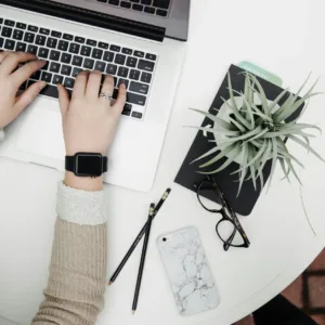 a person at their desk working on a laptop